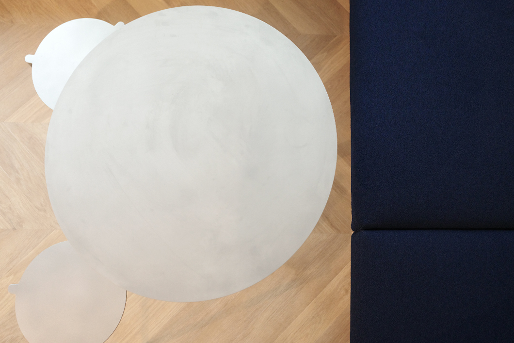 Fitness-Boutique, heller Raum, Brandschutzkissen, Metalltische und -Hocker, Vinylboden im Chevron-Muster